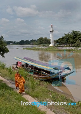 Ayuttaya Thailand- September 18 2016 : Priest Of Buddhist Walking Near River . They Take A Boat Trip Is A Routine Measure, Because They Are On An Island In The River Stock Photo