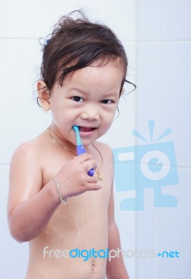 Baby And Toothbrush Stock Photo