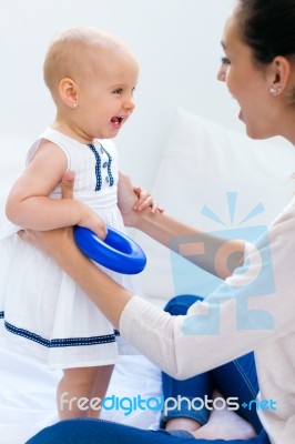 Baby Girl And Her Mother Playing At Home Stock Photo