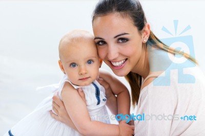 Baby Girl And Her Mother Playing At Home Stock Photo