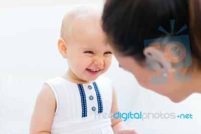 Baby Girl And Her Mother Playing At Home Stock Photo