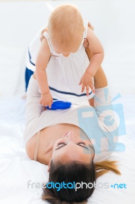 Baby Girl And Her Mother Playing At Home Stock Photo