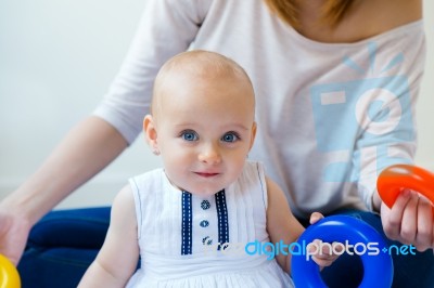 Baby Girl And Her Mother Playing At Home Stock Photo