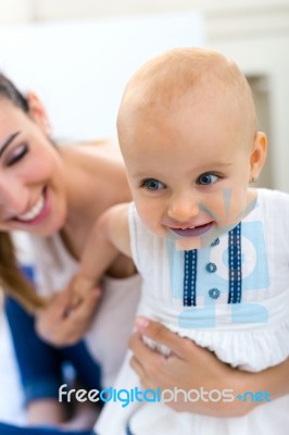 Baby Girl And Her Mother Playing At Home Stock Photo