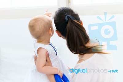 Baby Girl And Her Mother Playing At Home Stock Photo