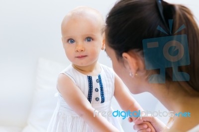 Baby Girl And Her Mother Playing At Home Stock Photo