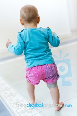 Baby Girl Learning To Walk At Home Stock Photo