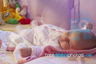 Baby Girl Rests In The Cradle Stock Photo