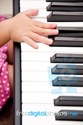 Baby Hand On Piano Stock Photo