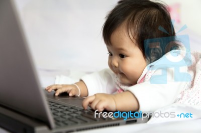 Baby Is Playing A Computer Stock Photo