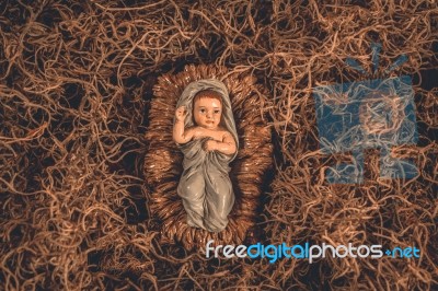 Baby Jesus Laying In A Manger Christmas Background Stock Photo