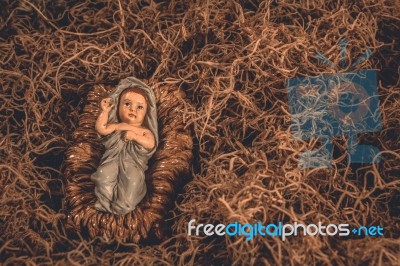 Baby Jesus Laying In A Manger Christmas Background Stock Photo