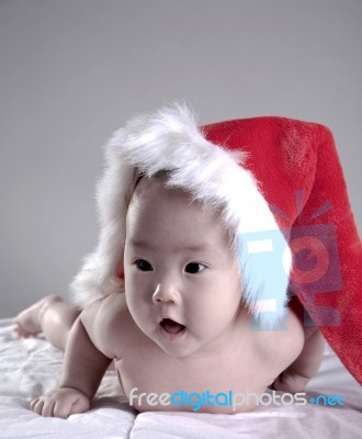 Baby Lying With Christmas Hat Stock Photo