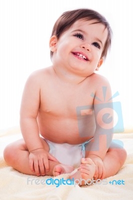 Baby Sitting And Smiling Stock Photo