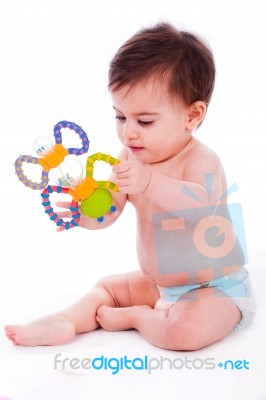 Baby Sitting With Diaper And Playing With Toys Stock Photo