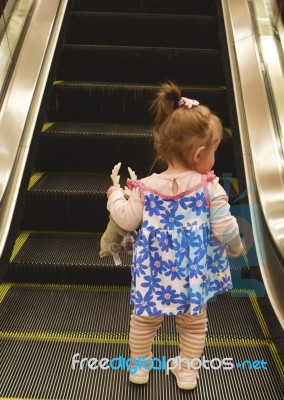 Baby Standing On Escalator Stock Photo