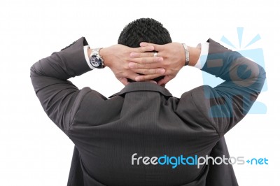 Back Of Businessman Holding Hands On Head On White Background Stock Photo