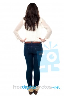 Back Pose Of A Girl With Hands On Hip Stock Photo