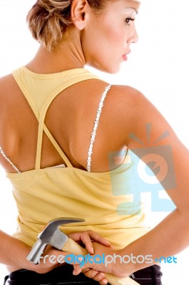 Back Pose Of Lady Holding Hammer Stock Photo