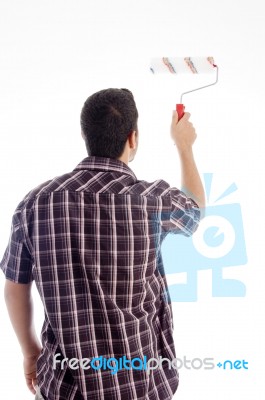 Back Pose Of Male Using Roller Brush Stock Photo