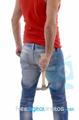 Back Pose Of Man Holding Hammer Stock Photo