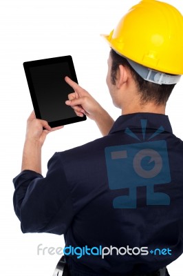 Back Pose Of Worker Operating Tablet Device Stock Photo