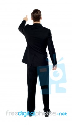 Back View Of Male Model Pointing Stock Photo