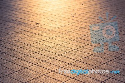 Background Texture Of Tile Roads And The Rays Of The Setting Sun… Stock Photo