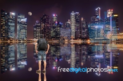 Backpacker And The Skyscraper Stock Photo