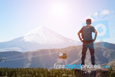 Backpacker Standing On The Rock Stock Photo