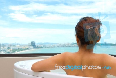 Backside Woman In Bathtub Looking Sea View Stock Photo