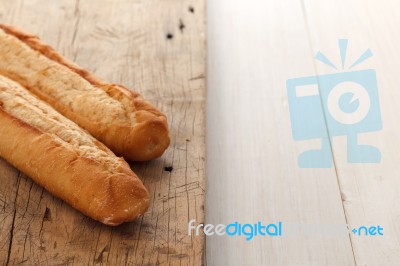 Baguette Bread On Rustic White Wooden Background Stock Photo