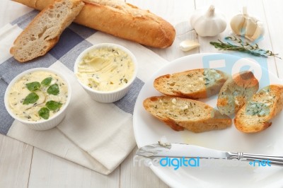 Baguette With Herb Butter And Rosemary Thyme On Rustic Wooden Background Stock Photo