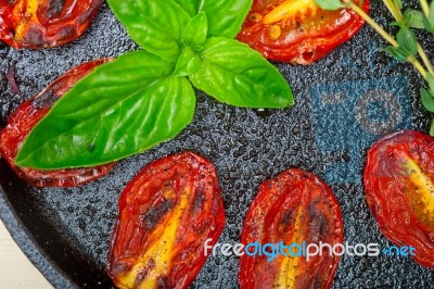 Baked Cherry Tomatoes With Basil Anf Thyme Stock Photo