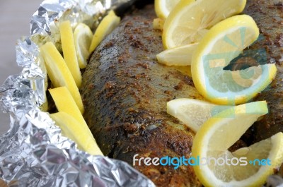 Baked Herring In Spices And Herbs In Foil Stock Photo