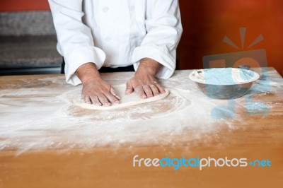 Baker Kneading A Dough Stock Photo