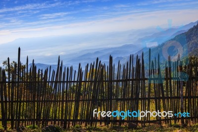 Bamboo Fence In Rural Field With Beautiful Natural Mountain Land Scape Wide Angle View Point Stock Photo