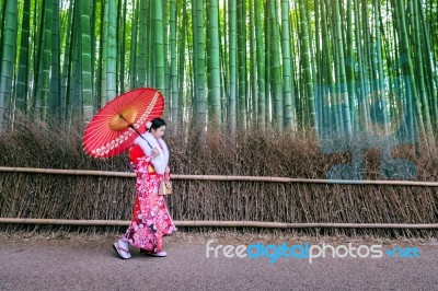 Bamboo Forest. Asian Woman Wearing Japanese Traditional Kimono At Bamboo Forest In Kyoto, Japan Stock Photo