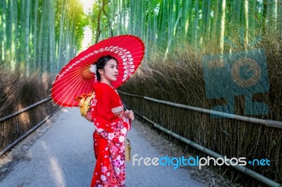 Bamboo Forest. Asian Woman Wearing Japanese Traditional Kimono At Bamboo Forest In Kyoto, Japan Stock Photo