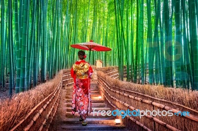 Bamboo Forest. Asian Woman Wearing Japanese Traditional Kimono At Bamboo Forest In Kyoto, Japan Stock Photo