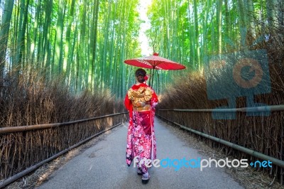 Bamboo Forest. Asian Woman Wearing Japanese Traditional Kimono At Bamboo Forest In Kyoto, Japan Stock Photo