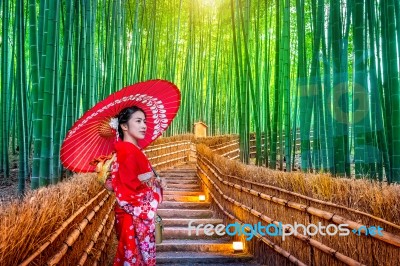 Bamboo Forest. Asian Woman Wearing Japanese Traditional Kimono At Bamboo Forest In Kyoto, Japan Stock Photo