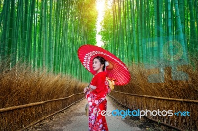 Bamboo Forest. Asian Woman Wearing Japanese Traditional Kimono At Bamboo Forest In Kyoto, Japan Stock Photo