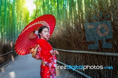 Bamboo Forest. Asian Woman Wearing Japanese Traditional Kimono At Bamboo Forest In Kyoto, Japan Stock Photo