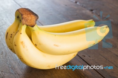 Banana On Brown Wooden Background Stock Photo