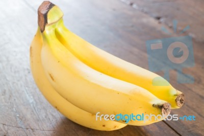 Banana On Brown Wooden Background Stock Photo