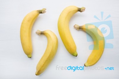 Banana On White Wooden Background Stock Photo