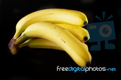 Bananas On Black Stock Photo