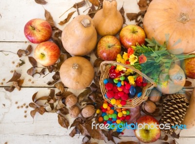 Basket With Halloween Candy And Autumn Decorations Stock Photo