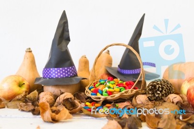 Basket With Halloween Candy And Autumn Decorations Stock Photo